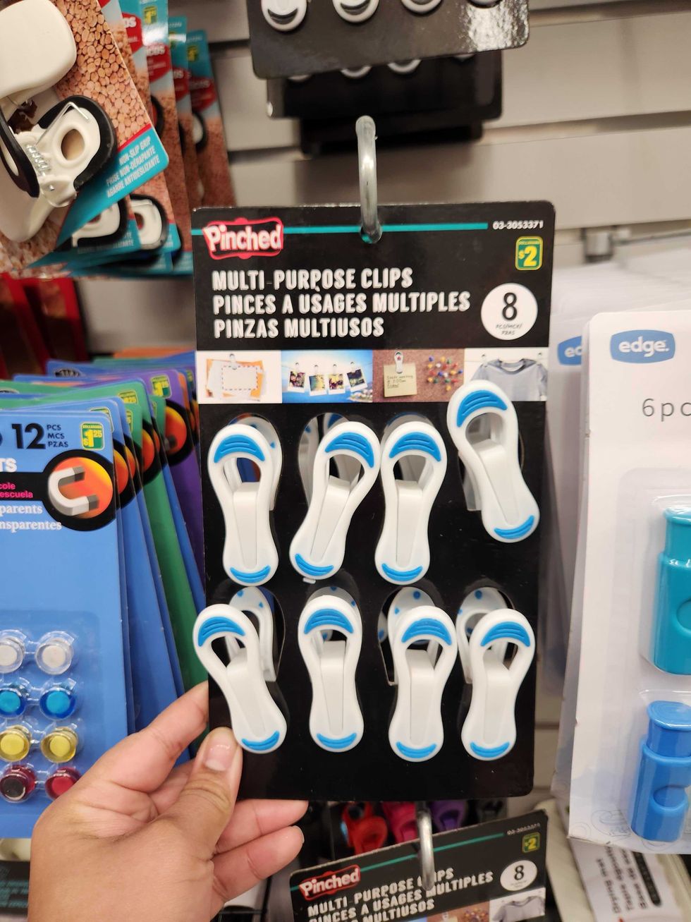 \u200bA hand holding multi-purpose clips.