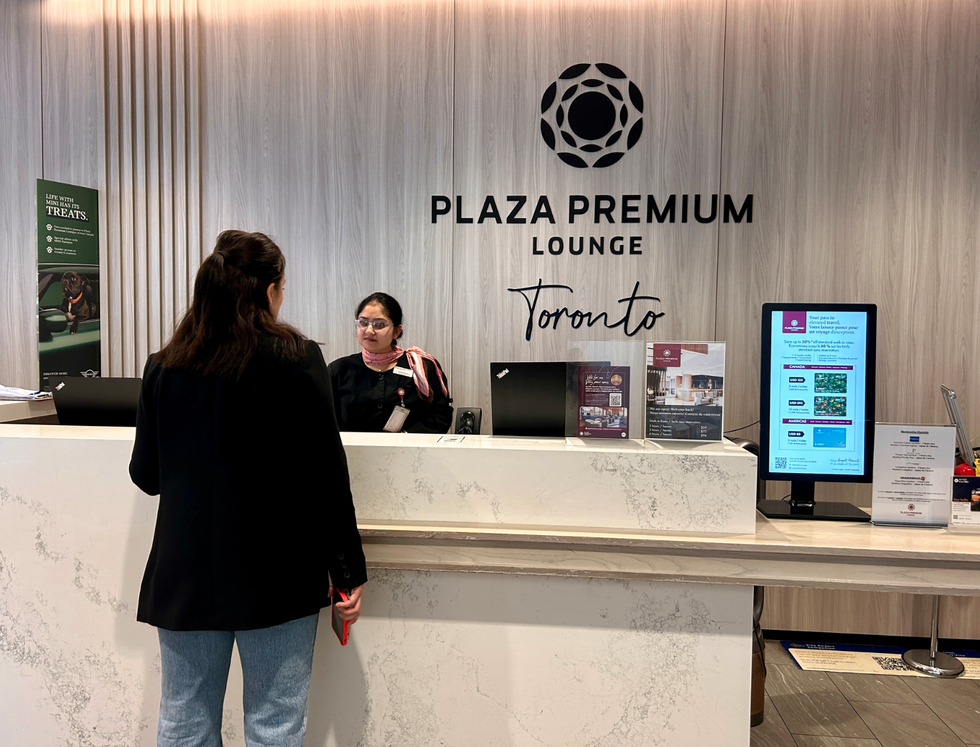 \u200bA person at the Plaza Premium lounge at Toronto Pearson Airport.