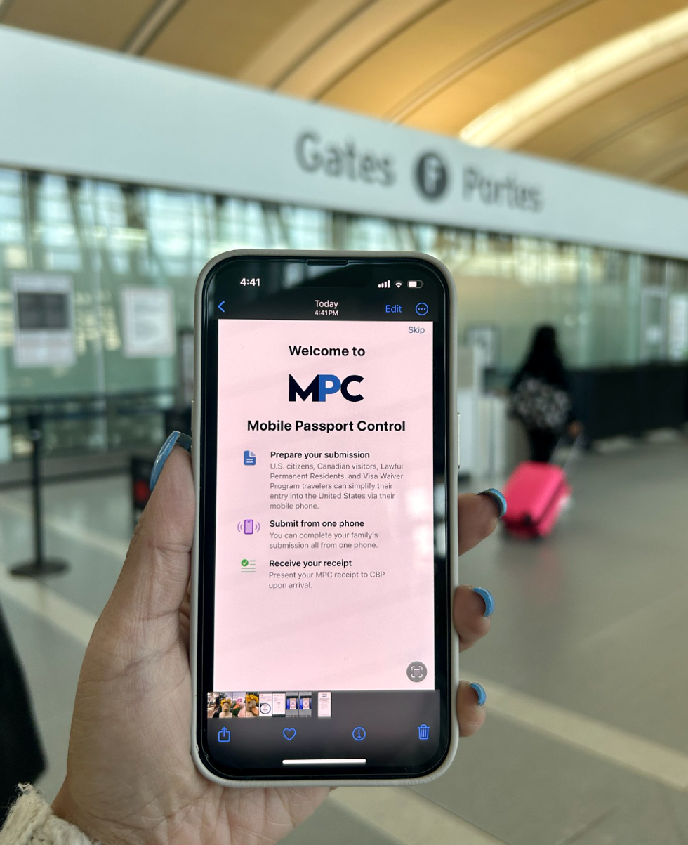 \u200bA person holds a cell phone with Mobile Passport Control.