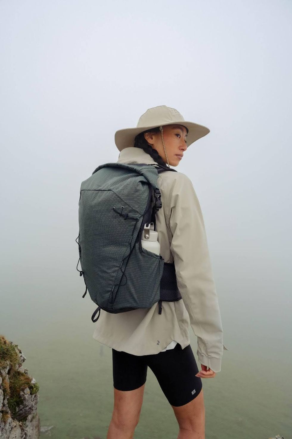 \u200bA person wearing a Decathlon lightweight backpack on a hike.