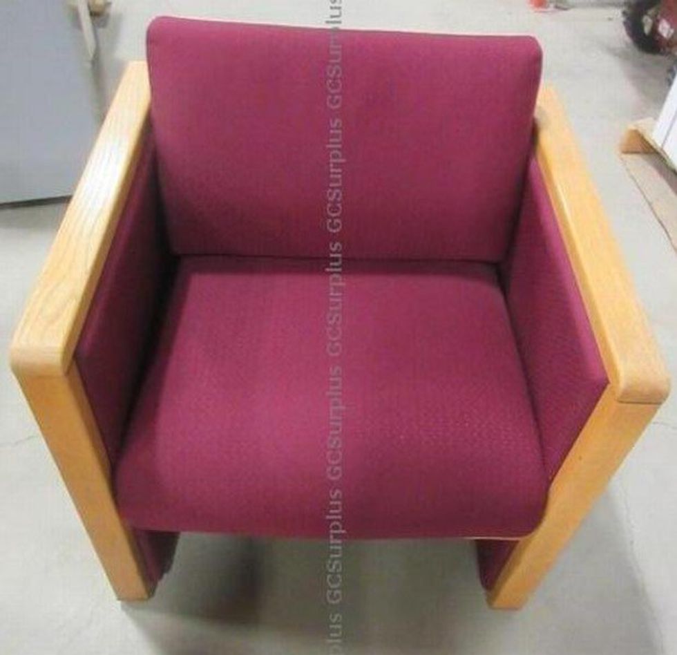 u200bA red chair with wooden accents.
