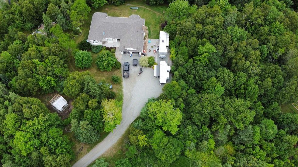 \u200bAeiral view of the house for sale in Nova Scotia that's surrounded by trees.