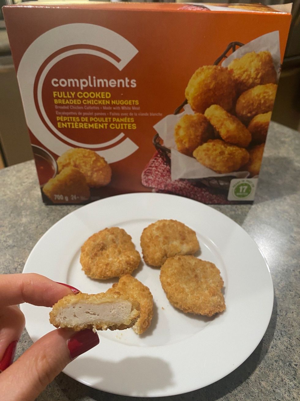 \u200bAsymina holding a Compliments chicken nugget.