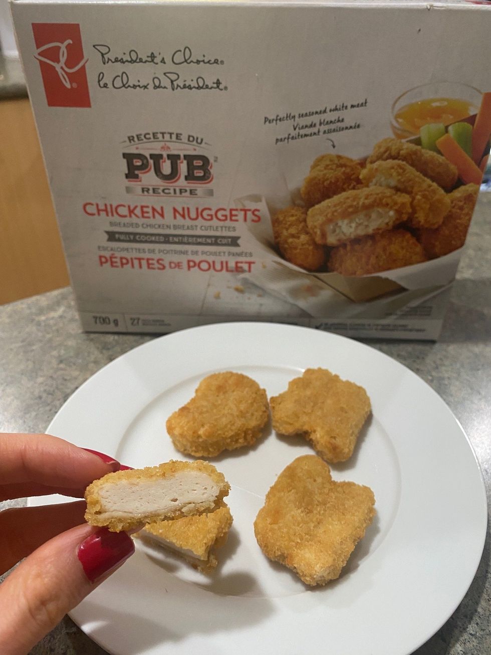 \u200bAsymina holding a President's Choice chicken nugget.