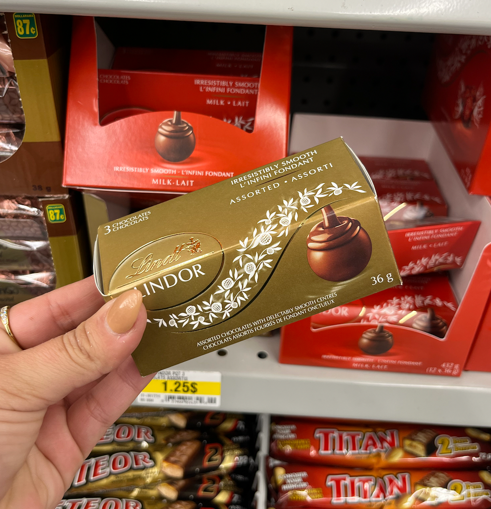 \u200bChocolats Lindor de Lindt dans leur petite bo\u00eete dor\u00e9e devant l'\u00e9talage des chocolats au Dollarama.