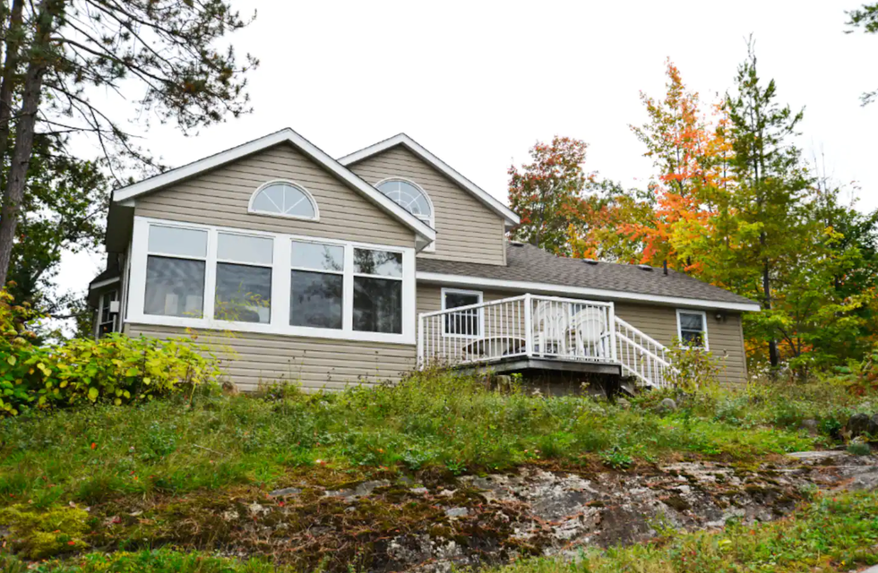 \u200bCottage surrounded by fall colours.