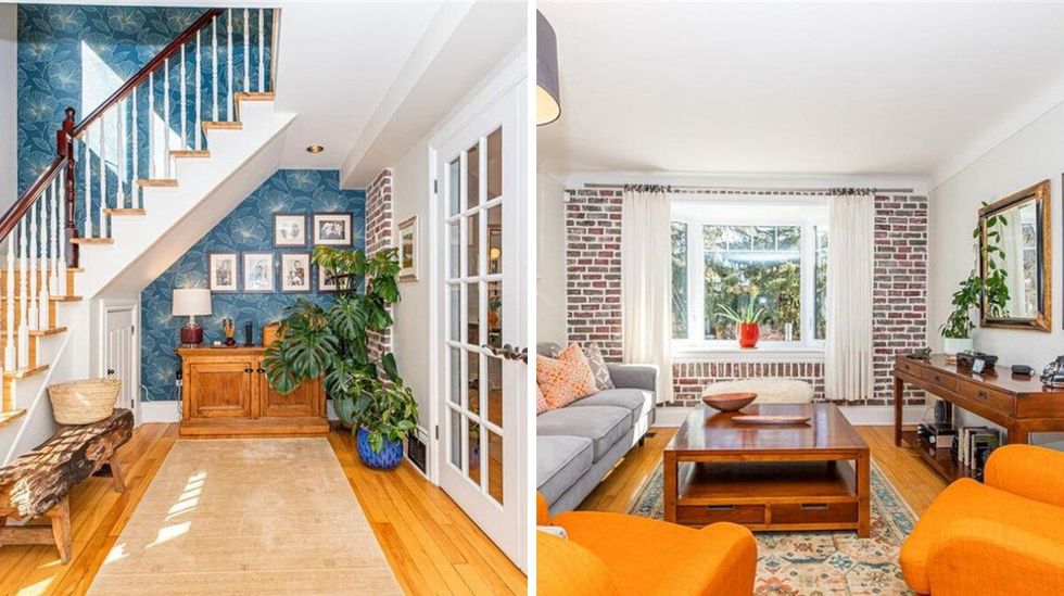 \u200bFoyer of the house for sale with a blue accent wall. Right: Living room of the home that has an exposed brick wall.