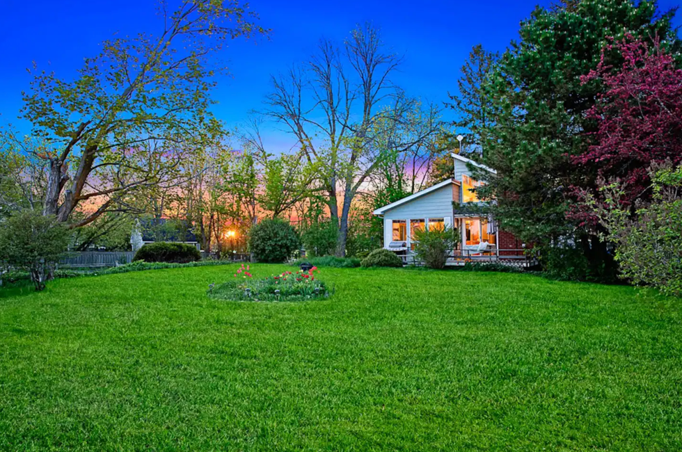 \u200bHome surrounded by grass and trees.