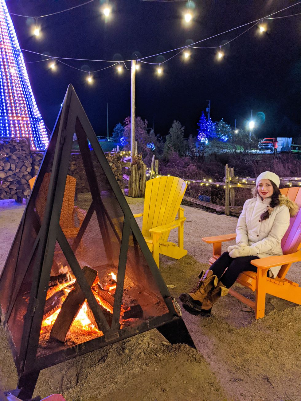 \u200bMadeline sitting by a fire.