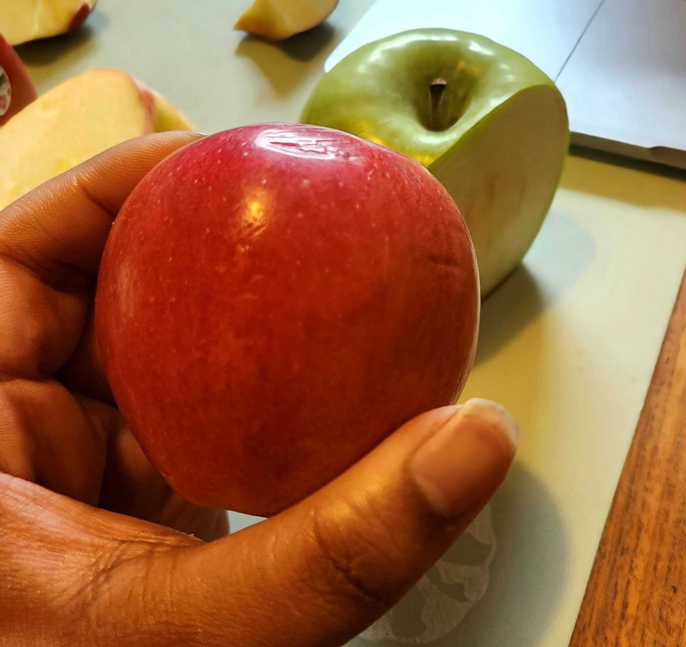 \u200bSarah holding a Gala apple from Walmart.