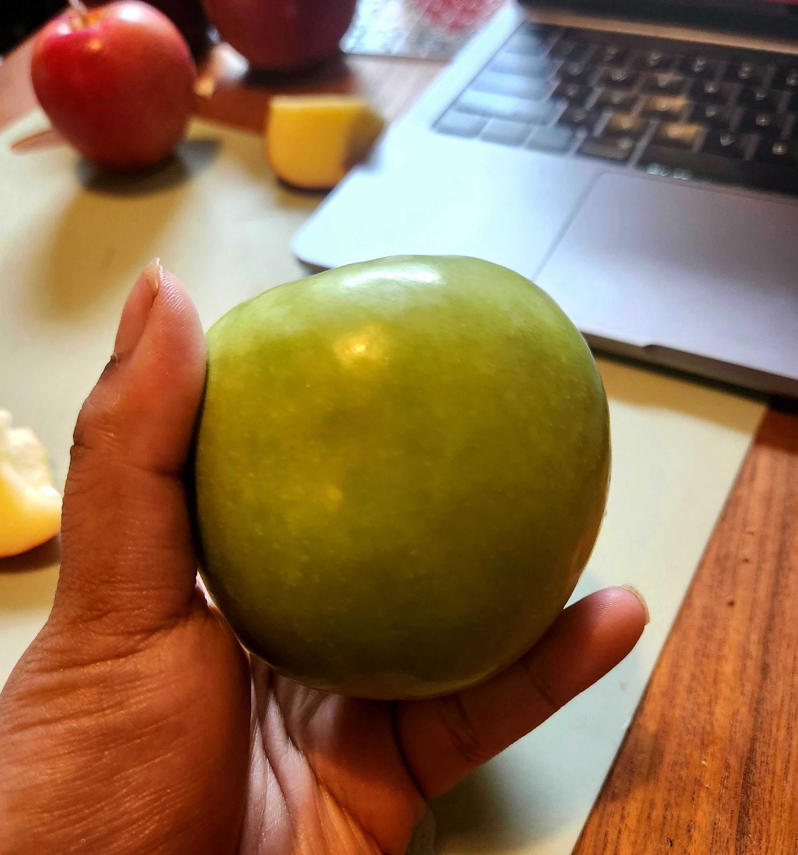 \u200bSarah holding a Granny Smith apple from Walmart.