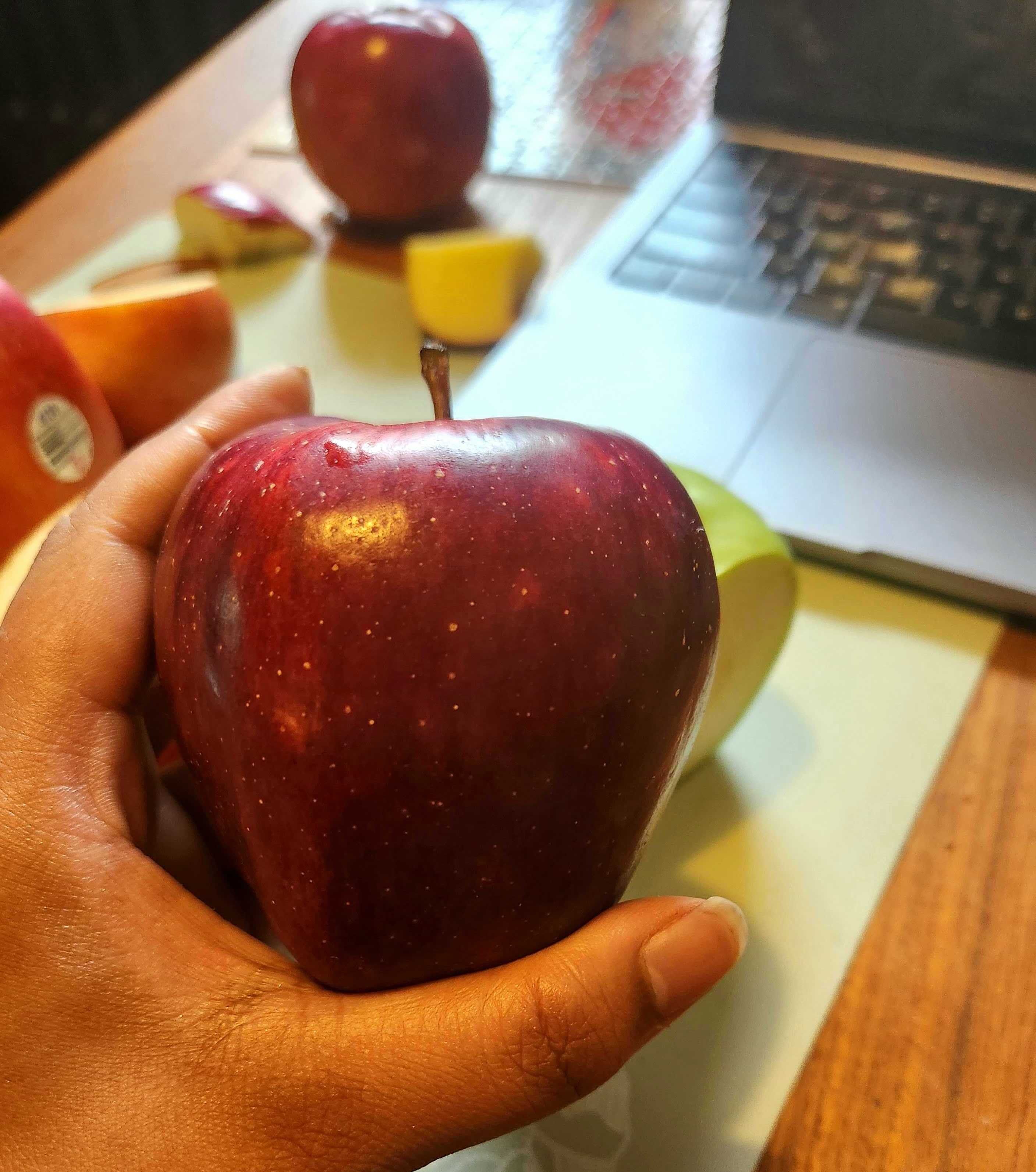 \u200bSarah holding a Red Delicious apple from Walmart.