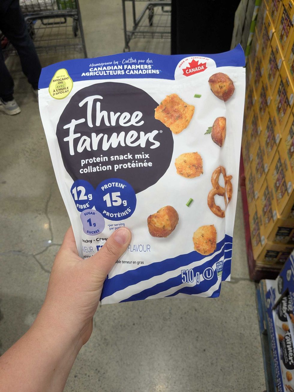 \u200bSomeone holding a package of a Costco protein snack mix