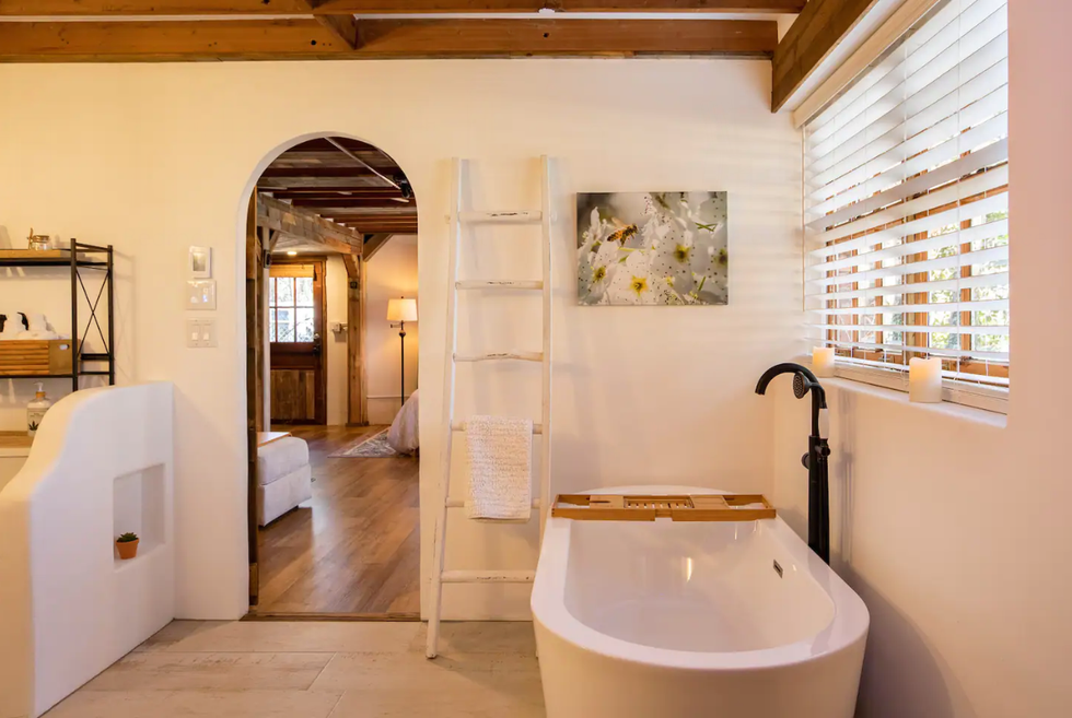 \u200bThe bathroom at Suite B with arched doorways and a standalone bathub.