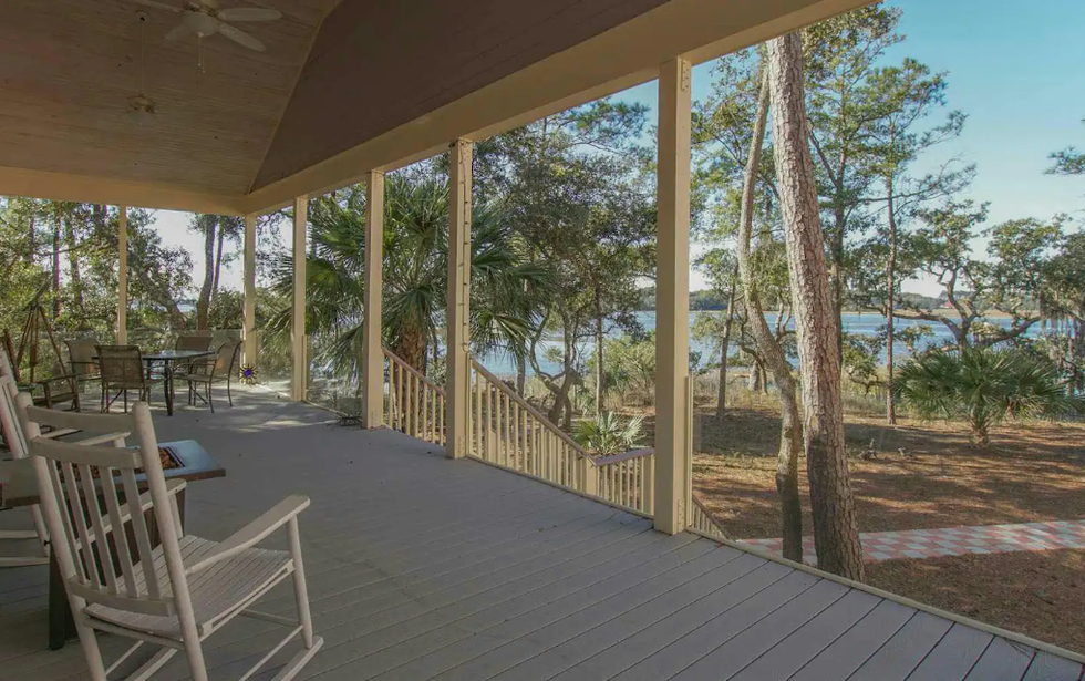 \u200bThe front porch at the Private Island Cottage overlooking the water.