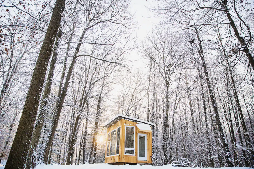 \u200bTiny cabin in a snowy forest.