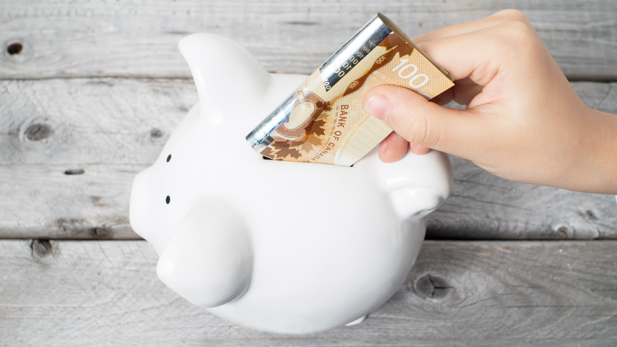 Un cochon blanc en porcelaine avec un billet de 100 $ au-dessus.