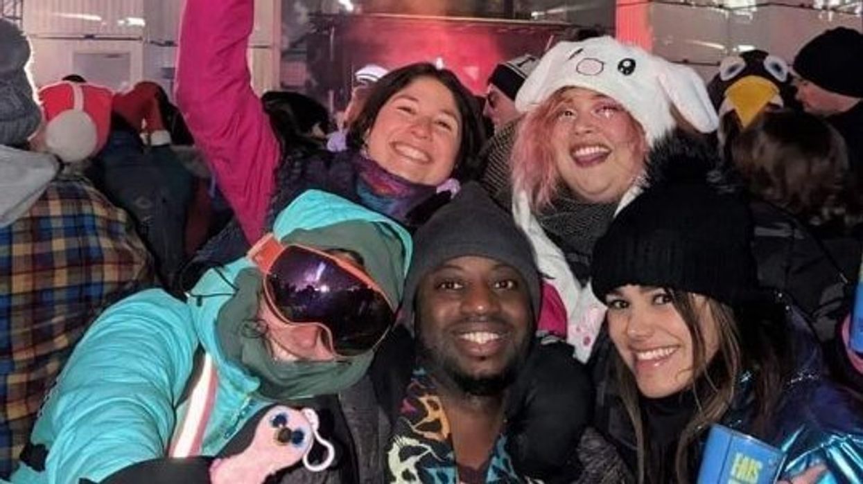 Un groupe de cinq personnes en vêtement d'hiver dans la foule devant une scène à Igloofest.