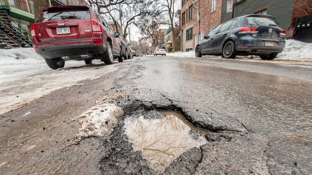Un nid-de-poule et des voitures, à Montréal.