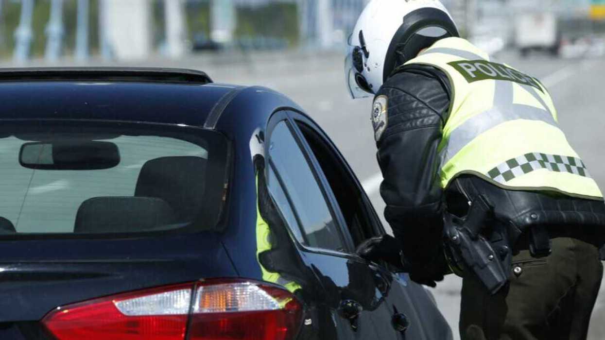 Un policier de la Sûreté du Québec qui intercepte une voiture.