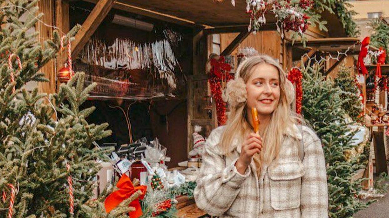 une personne avec un bâton de tire d'érable à la main au Village de Noël du Marché Atwater