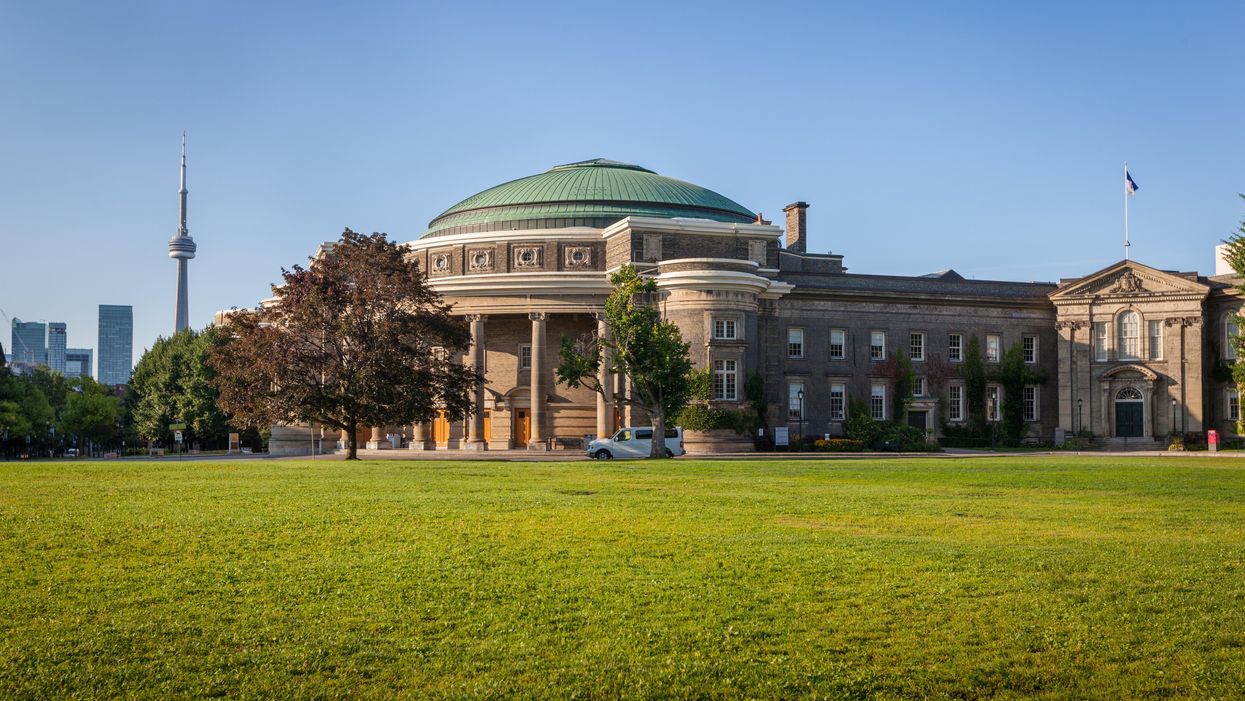University of Toronto's Convocation Hall with the CN Tower in the background.