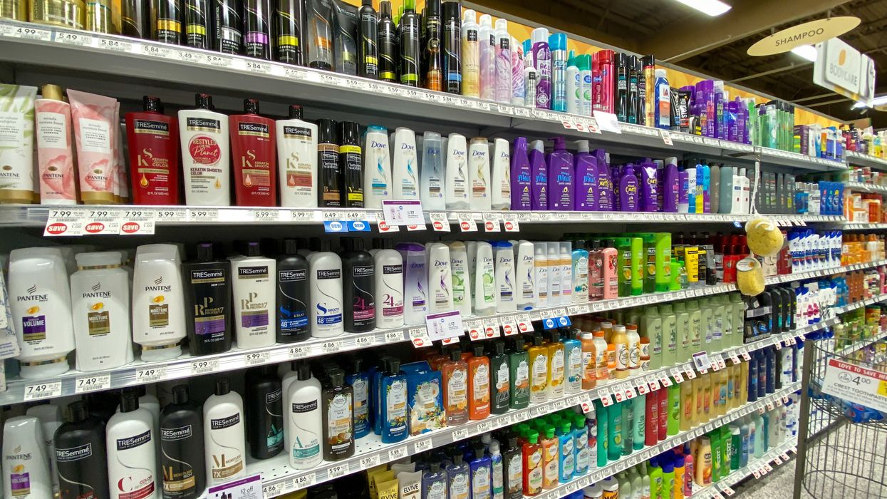 Various haircare products stacked on shelves in a pharmacy in Canada.