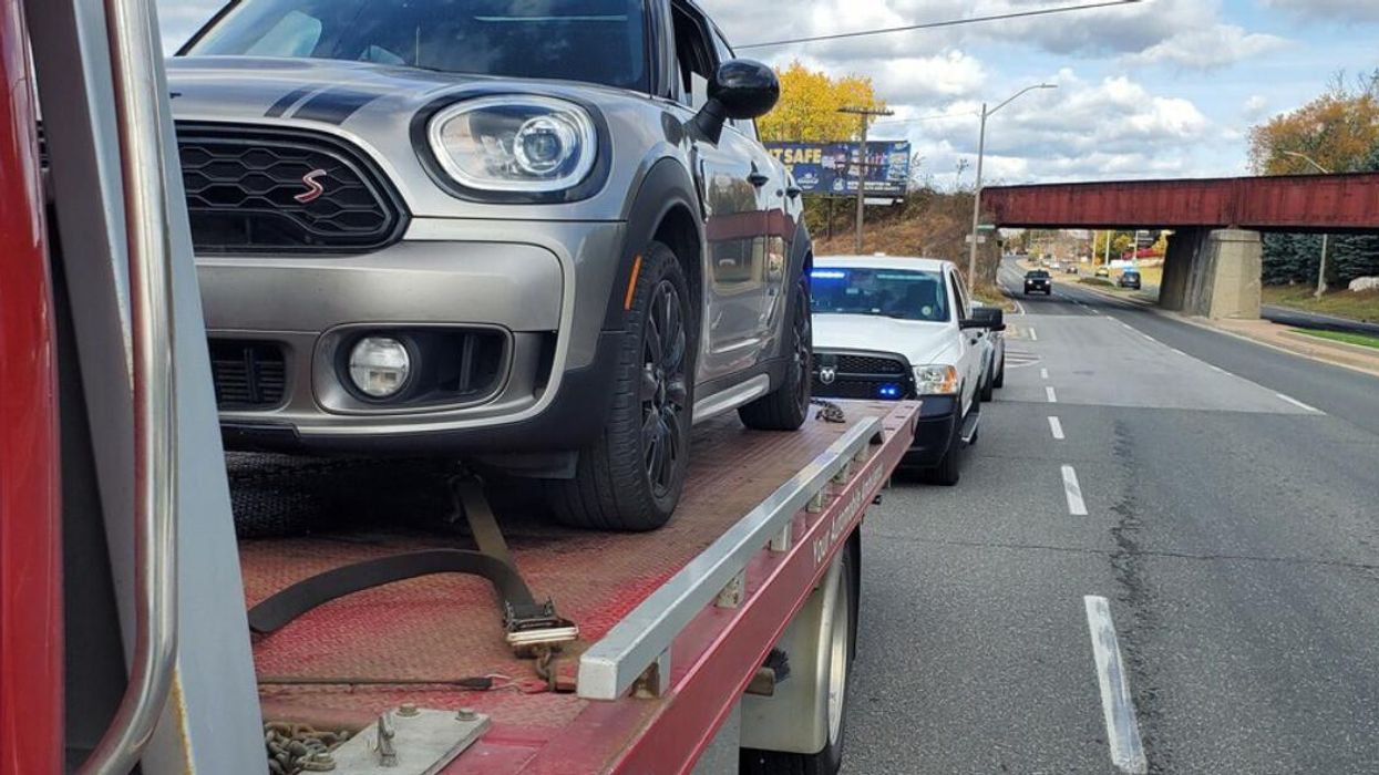 Vehicle on a tow truck bed after being pulled over by police.