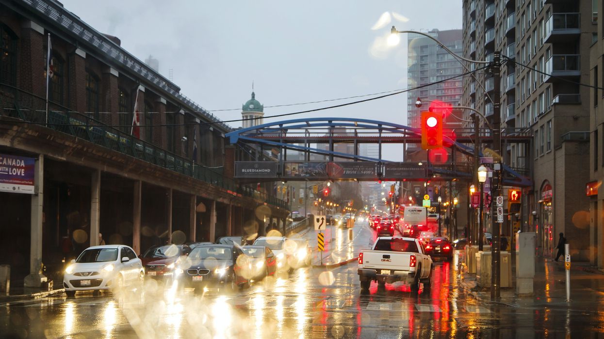 Vehicles in traffic on a rainy evening in Downtown Toronto.