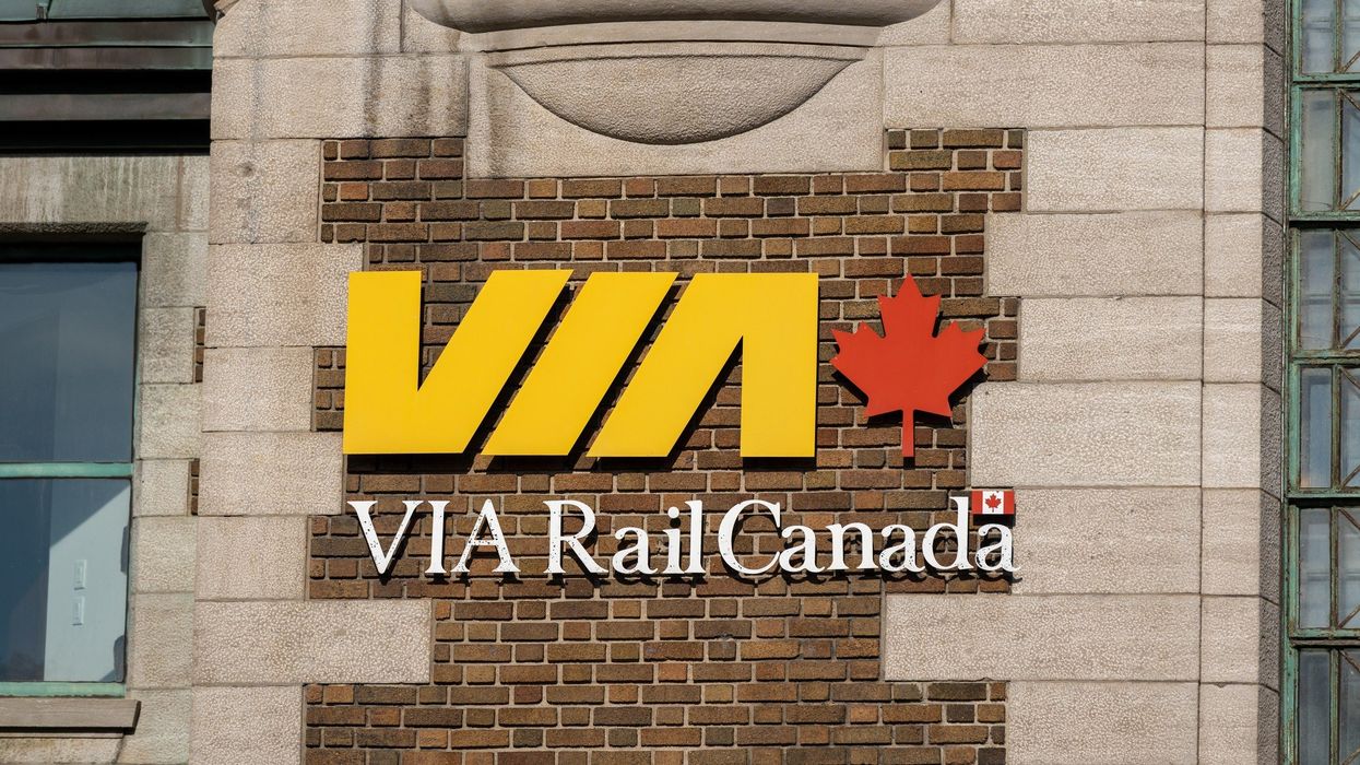 via rail sign on train station building in canada