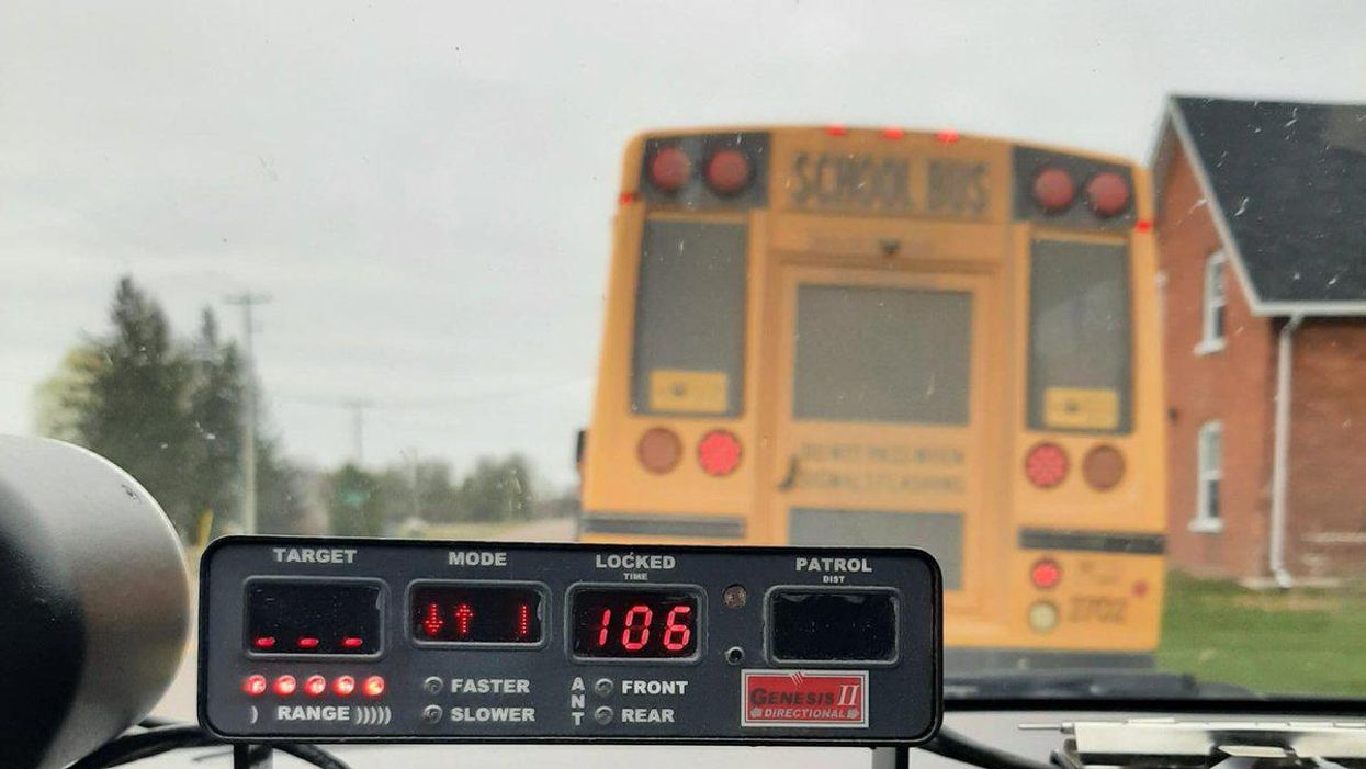 View from a police car of a bus being pulled over by OPP.