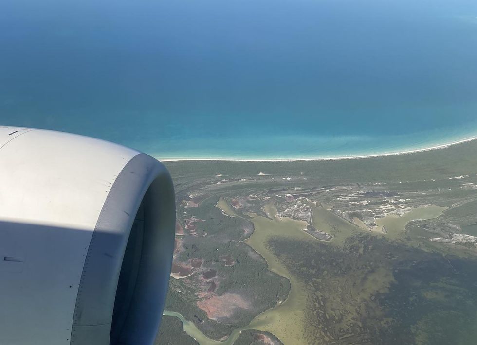 view from the plane window on a swoop flight from Toronto preparing to land in Cancun, Mexico