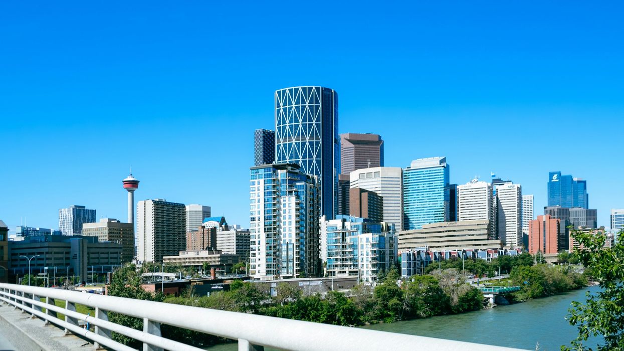 view of calgary city buildings from a bridge over a river
