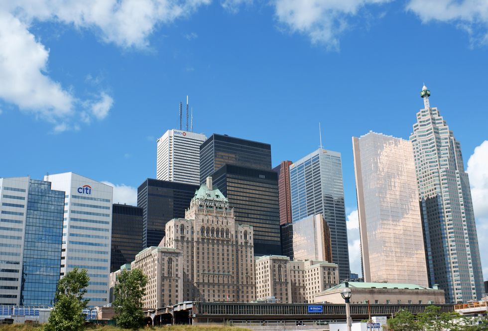 View of the Fairmont Royal York Hotel against modern skyscrapers.