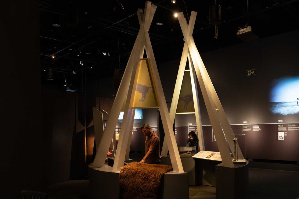 Visitors in the tipi featuring dr. linda manyguns' design.