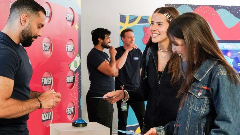 Visitors participating in an interactive activity at Fidelity's ETF pop-up.