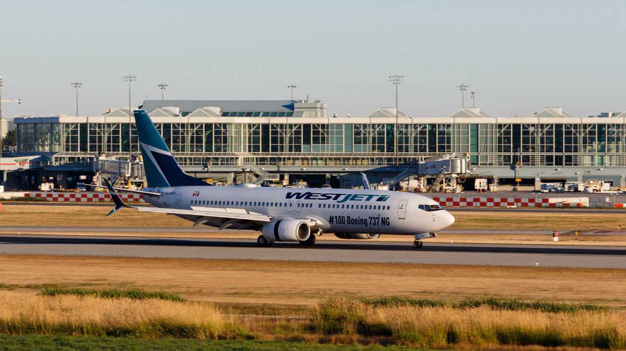 westjet plane with canadian airport in background