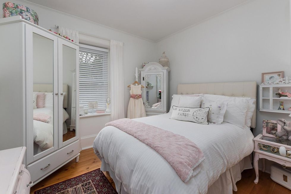 White bedroom with a dresser.