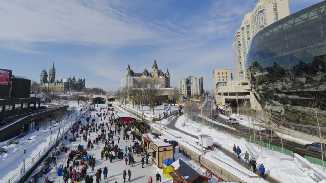 Winter view of Ottawa's Rideau Canal with Parliament Hill in the distance.