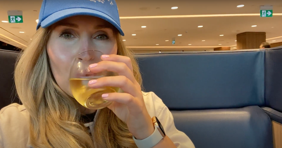 woman drinking wine in plaza premium international lounge terminal 3 pearson airport