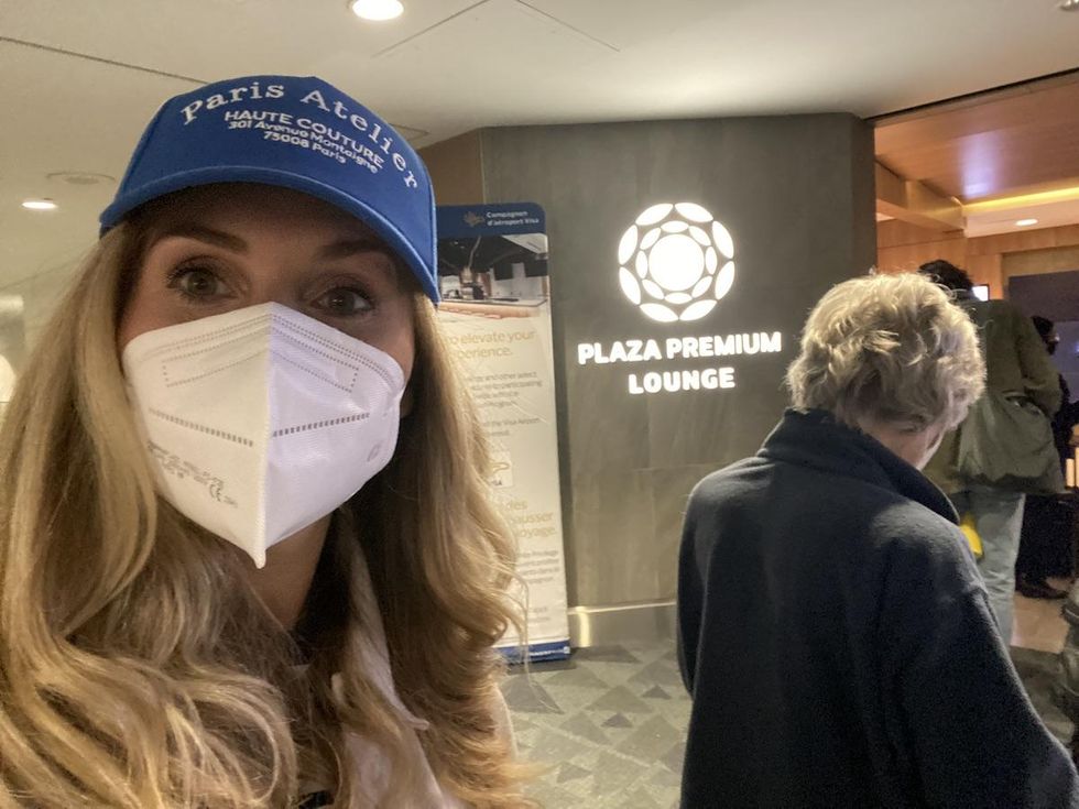 woman in front of plaza premium international lounge terminal 3 pearson airport
