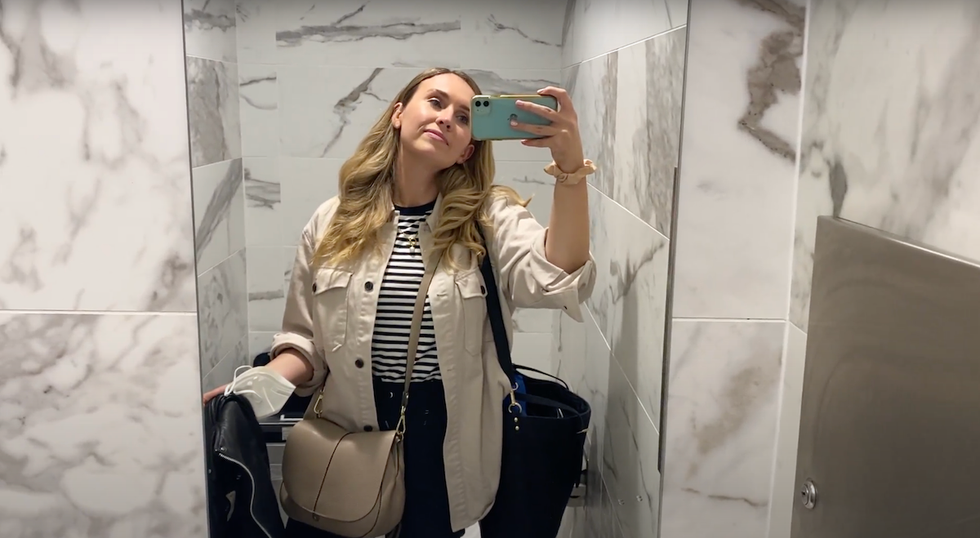 woman inside bathroom at plaza premium international lounge terminal 3 pearson airport