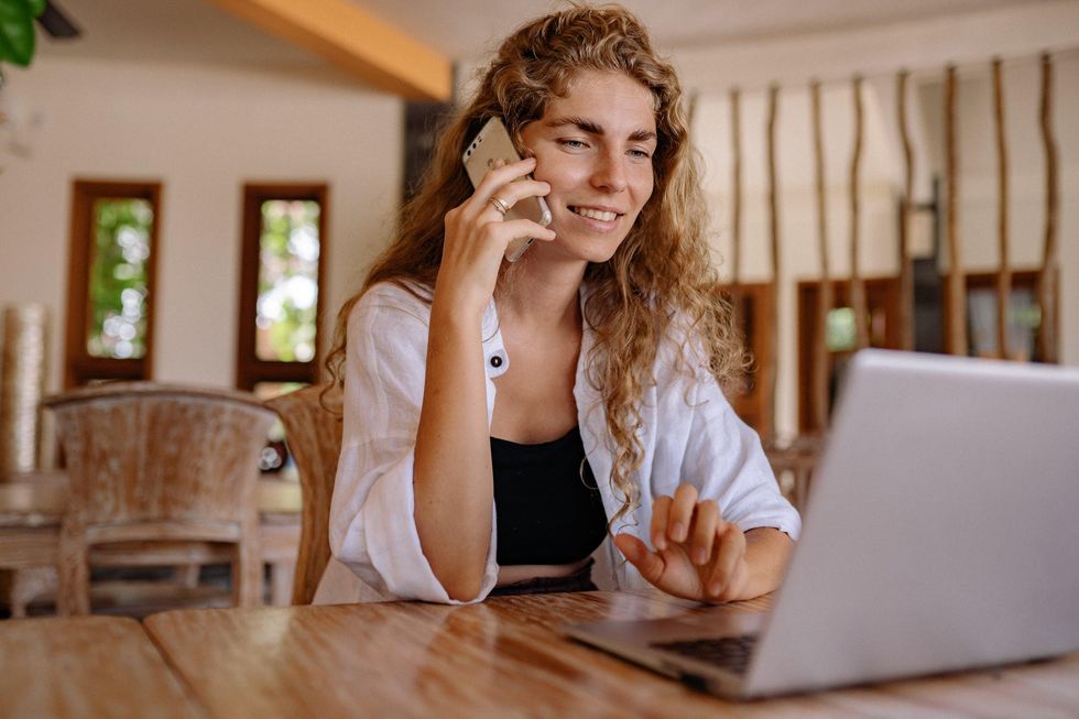 Woman on the phone using laptop