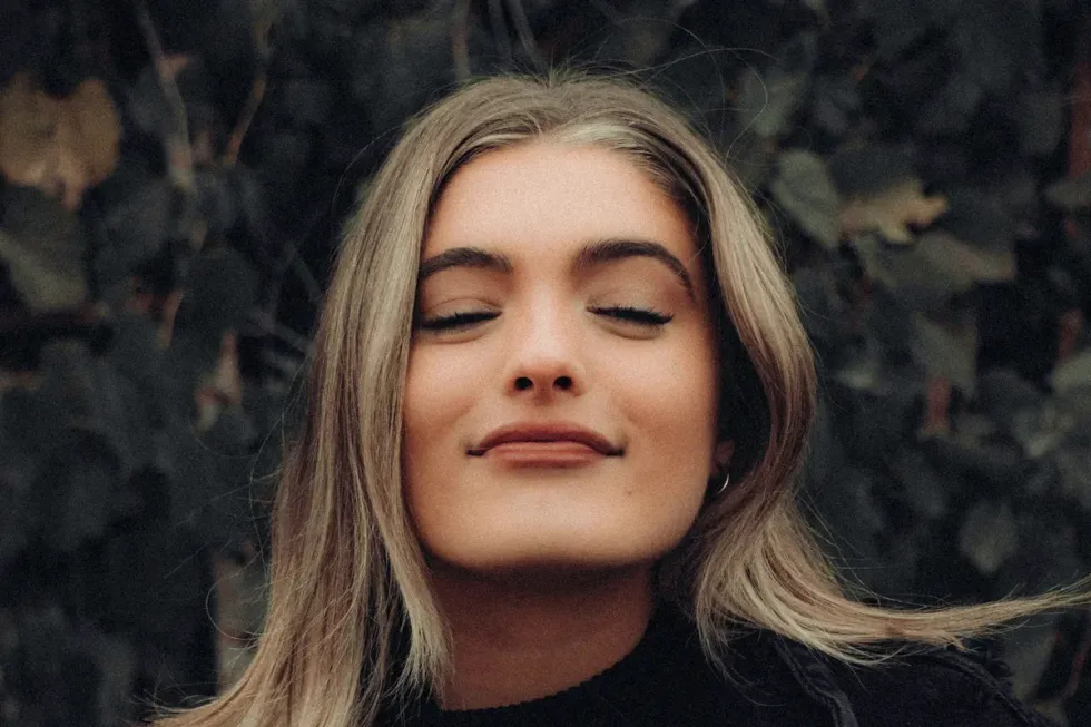 woman with eyes closed for dare