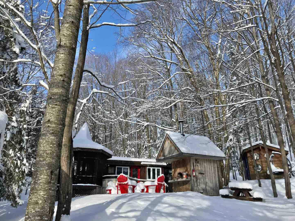 Wood chalet covered in snow.