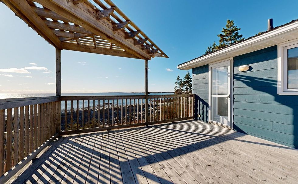 wooden deck at the back of the house ovelrooking the ocean