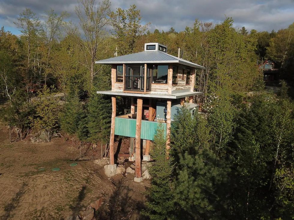Wooden treehouse cabin in the forest.