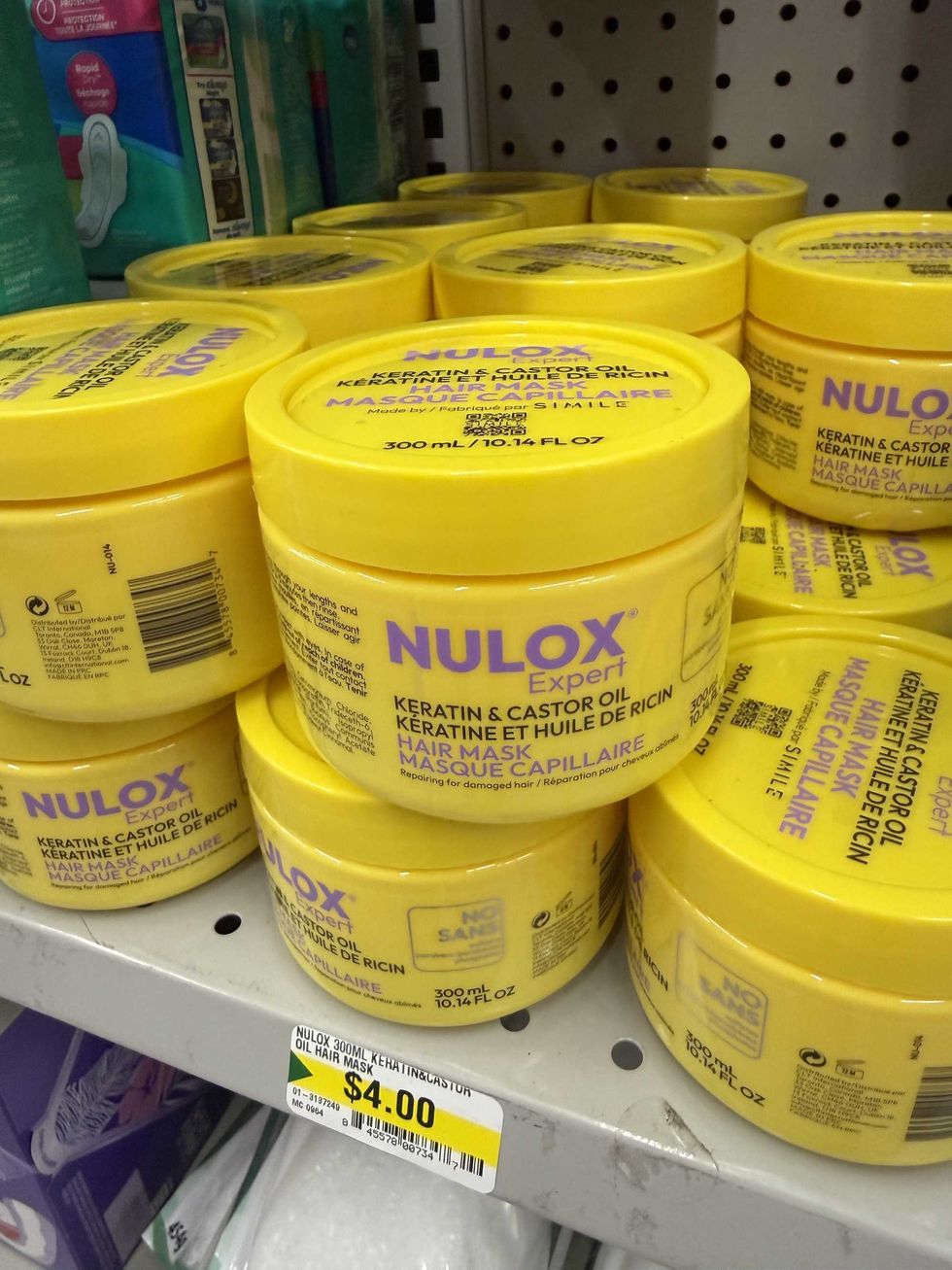 Yellow containers on a store shelf that say Nulox Expert hair mask on them.