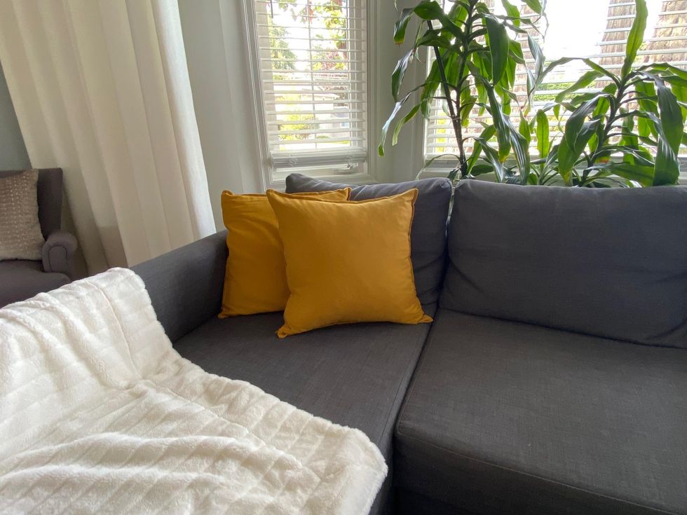 Yellow throw pillows on a couch.