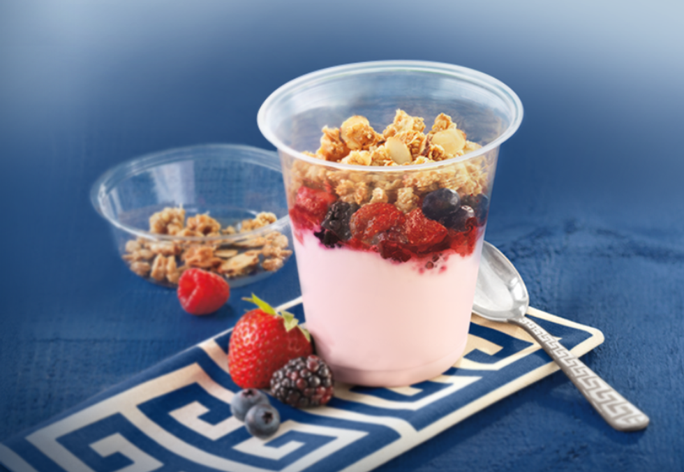 Yogurt parfait topped with granola and berries.